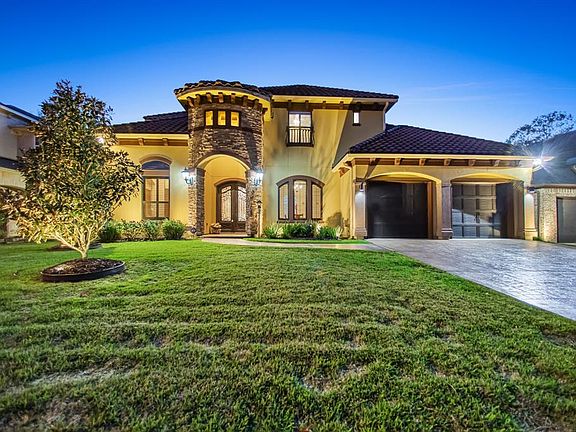 Pattern concrete drive way that looks like stone, stunning exterior lighting and a three car over-sized tandem garage is just the beginning to this top of the line custom home