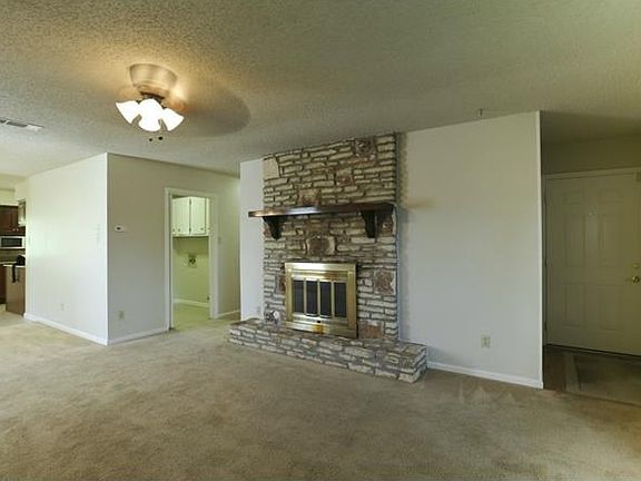 Living room as you enter home- gorgeous custom wood mantle, fireplace burns wood