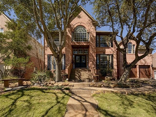 Stunning front yard with large oaks on a quiet street with sidewalks make this home ideal for so many.