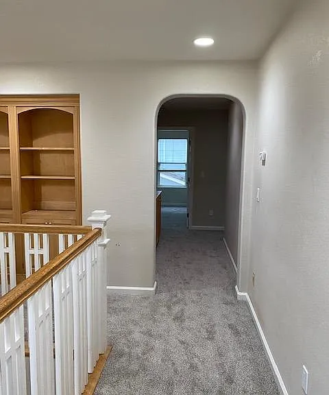 Upstairs hallway with built-in cabinets and new carpet