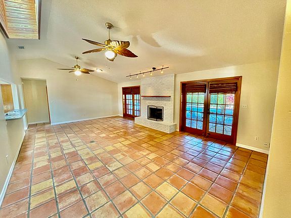 Front room with lighted fans and fireplace - skylight