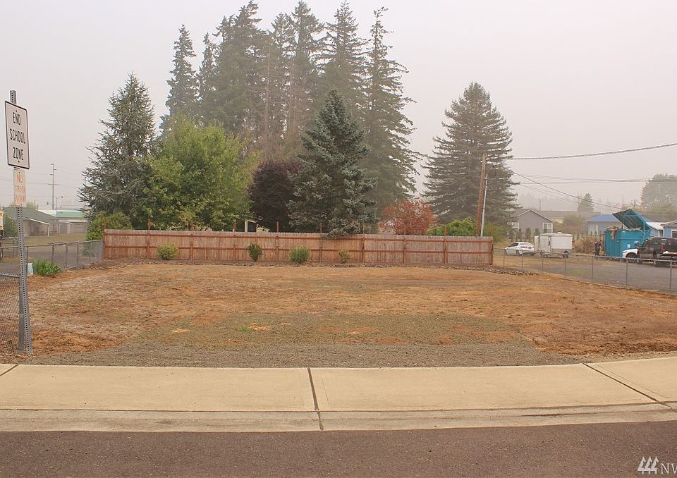 Corner lot is partially fenced.  Driveway approach in sidewalk.  Great location for residence or commercial