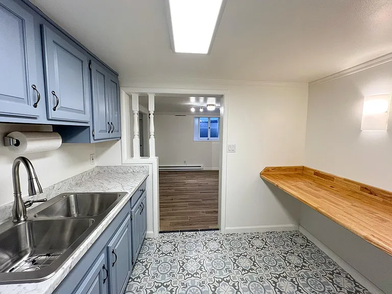 Kitchen, featuring porcelain floor and real solid-wood butcher-block table