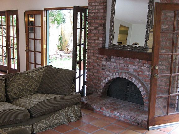 Tile flooring, Fireplace, and Wall to Wall French Doors makes this a Home