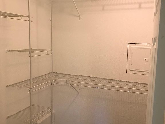 Walk-in closet in master bedroom.