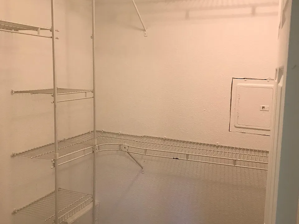 Walk-in closet in master bedroom.