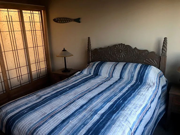 Headboard & nightstand hand carved by Elidio Gonzalez in 1937 in Taos New Mexico-triple shoji closet doors lit from within by LED strip lighting. Bedroom 140sf