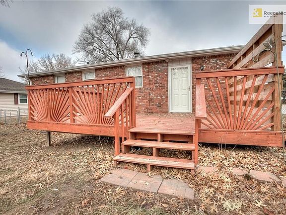 The back of the home with a private deck. There is a new privacy wall screen to the side of the deck.
