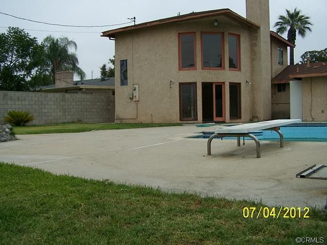 Back of home, showing pool and grassy area