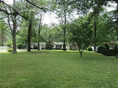 Home sits well back off the road for optimal privacy and wooded setting.