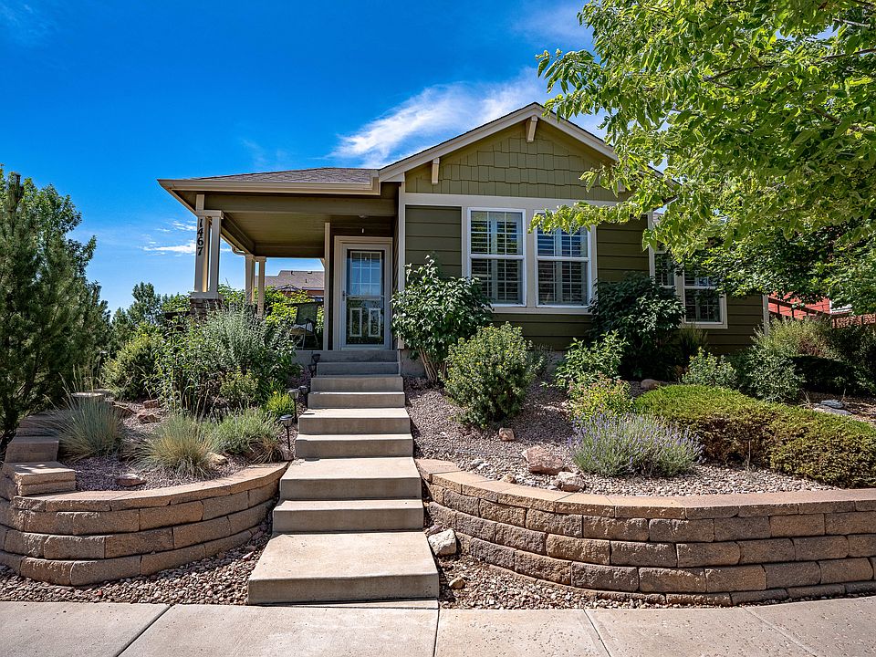 Front of home on quiet street with view of Garden of the Gods - HOA takes care of front landscaping. 2 car garage entrance in the back. Only one step in to the home from the garage for easy entry and moving.