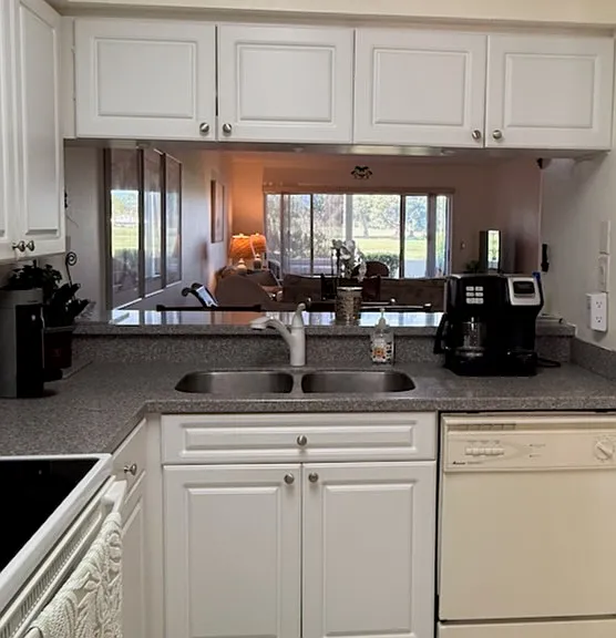 Kitchen with breakfast bar looking through to dining and living area