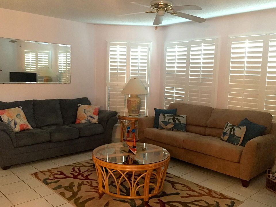 Living room with 2 full-sized sofas. Plantation shutters ope