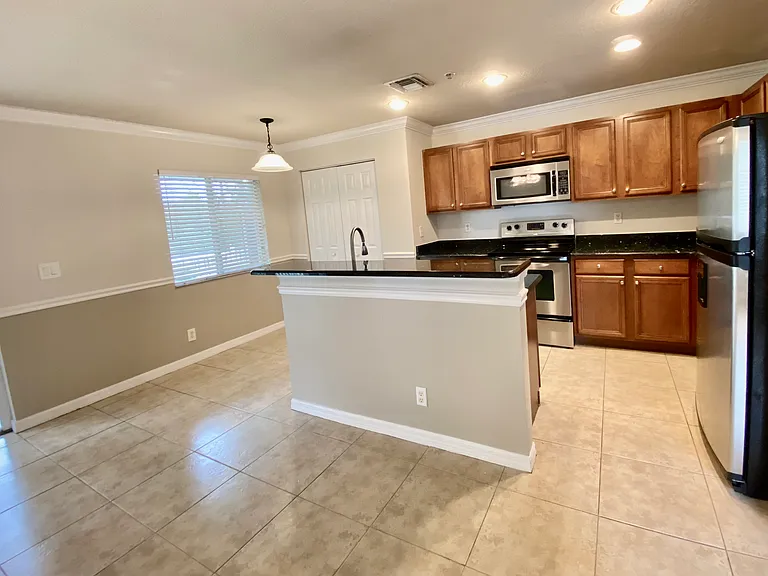 Kitchen with dining nook and island with area for bar stools.