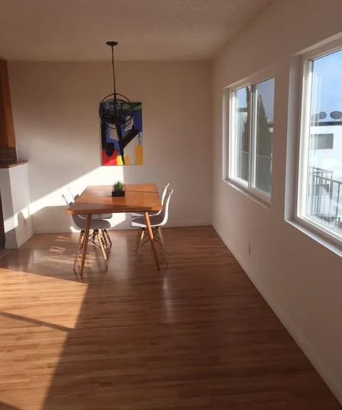 Long shot of dining off kitchen and all the west facing view windows.