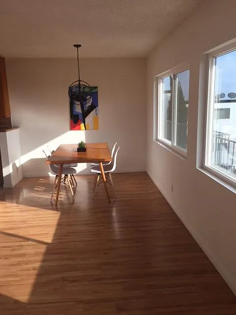 Long shot of dining off kitchen and all the west facing view windows.