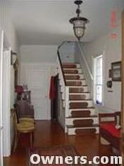 The foyer, copper kick plates on the stairs