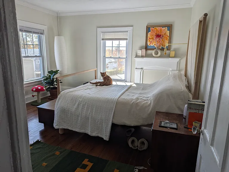 Light drenched master bedroom with three large windows provides plenty of space for a queen (or king) bed. Original fireplace mantle serves as a great place for your art and knick-knacks.