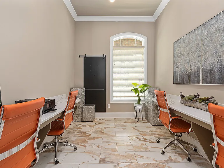 Chic business center with stylish orange chairs, modern desks, and elegant decor, ideal for productivity and inspiration.
