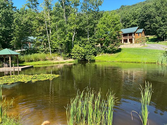 This photo was taken in late august. most photos were from Early spring before property greened up! (my golden retrievers tail seen in bottom of pic-she loves swimming in the pond!)