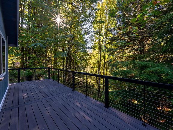 Brand new composite deck with metal railing facing the greenbelt you can hike into!