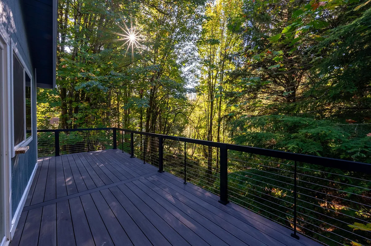 Brand new composite deck with metal railing facing the greenbelt you can hike into! - 136 Windward Dr