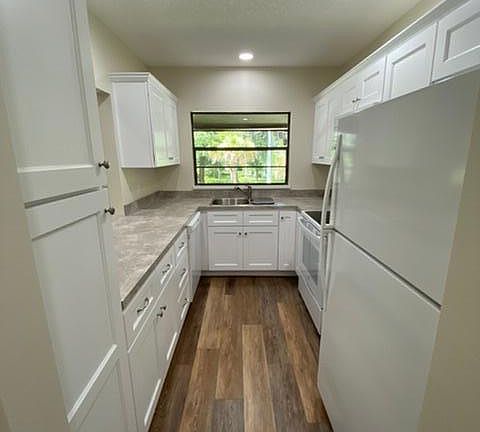 Fully renovated gallery kitchen with new appliances. Includes: fridge, microwave, oven, range and dishwasher.