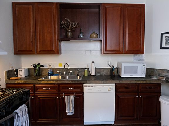 The fully equipped kitchen features a gas range and a dishwasher