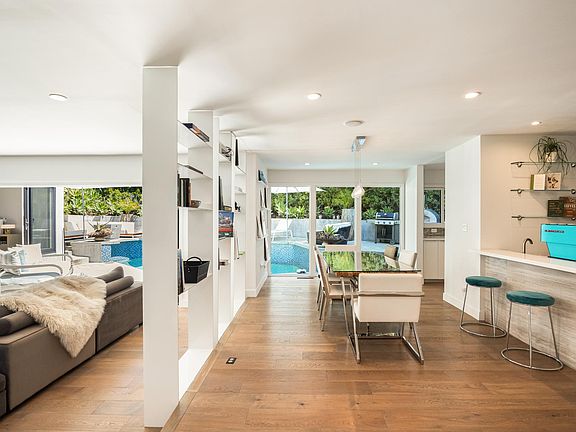 Seamlessly blending, the dining area in the open living space offers an elegant setting.