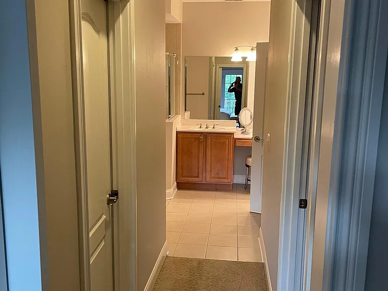 Walkway from Master Bedroom to two walk-in closets on either side and Master Bath.