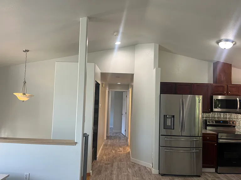 hallway towards full bath (on right), main bedroom suite w/ full bath (on right), second bedroom (straight ahead), third bedroom (on left)