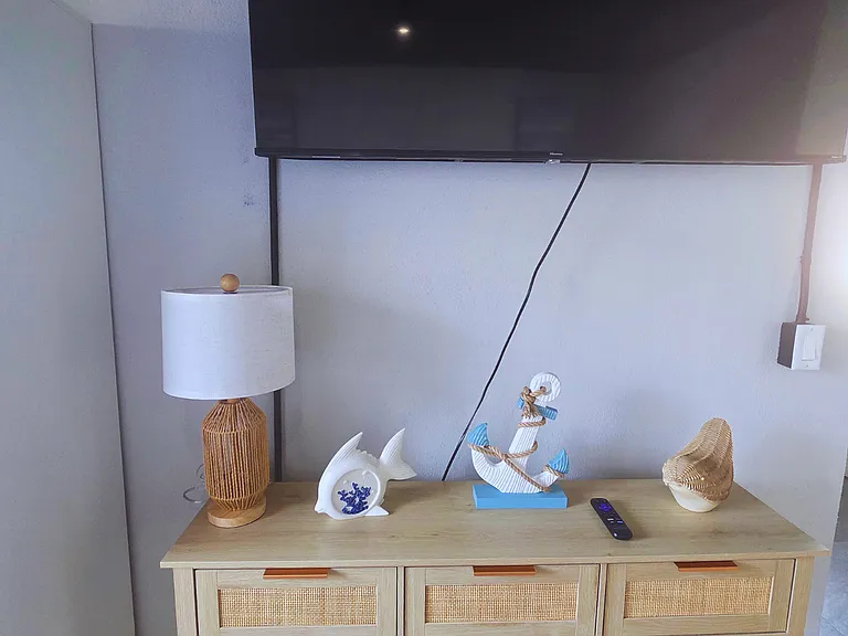 Beach-inspired coffee table with anchors, fish decor, and elegant lighting.