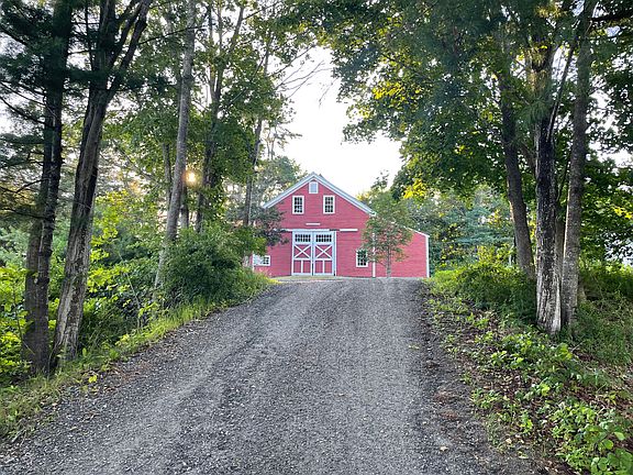 Neighbor's barn at foot of driveway next to house.