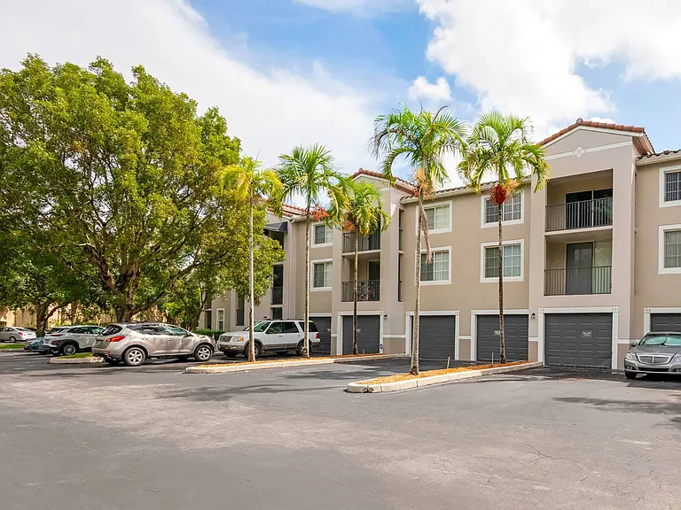 Admire the elegant exterior, complete with covered parking and available garages for added convenience.