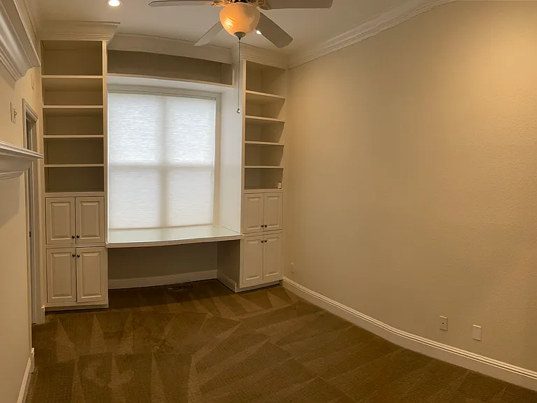 Bedroom with built-in shelves and desk area (shared bathroom)