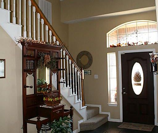 Grand tiled entry with two story ceiling.