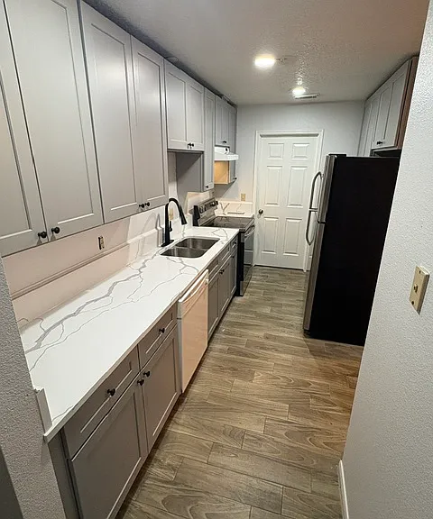Kitchen with new cabinets, appliances, and new tiled floors