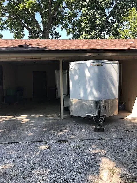 Carport is large enough to fit most vehicles- trailer shown for size.