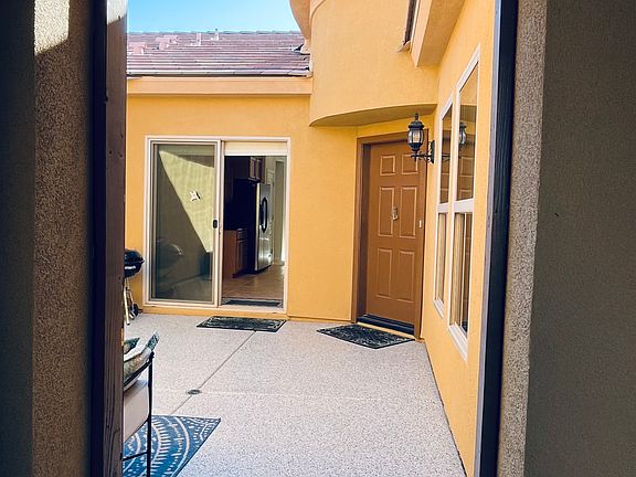 Entry to private gated front courtyard, and front door, sliders to kitchen.