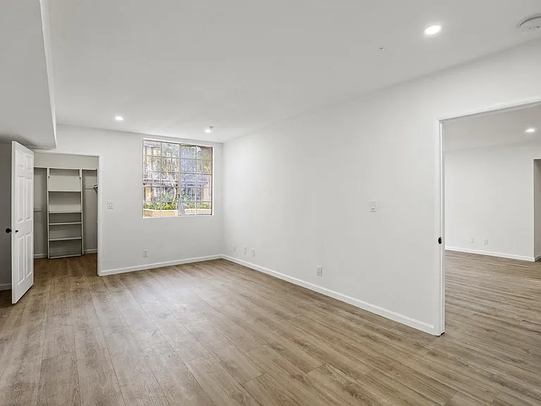 Bedroom with Large Walk-In Closet with Built-In Organizers