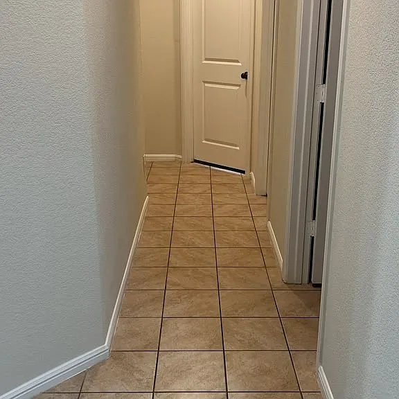 Hallway leading to Laundry room on the right, followed by the guest bathroom, followed by a 3rd and 4th bedroom at the end of the hallway.