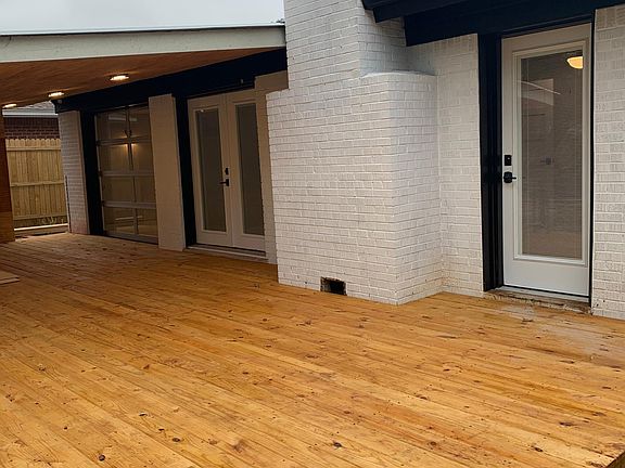 NEW 500' WOOD COVERED DECK WITH FRENCH DOORS TO KITCHEN/DINING AND ENTRY TO MASTER SUITE