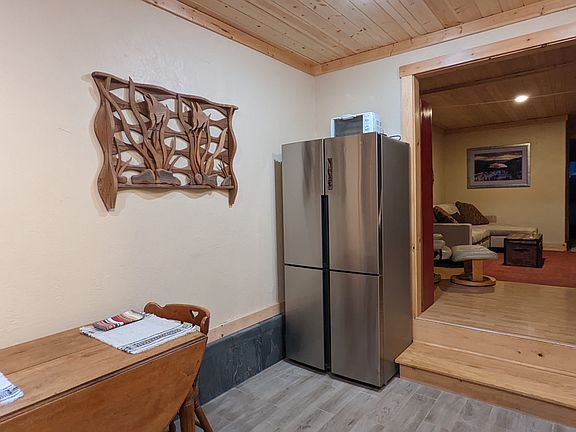 Kitchen with step up to living room. Small bedroom is off kitchen