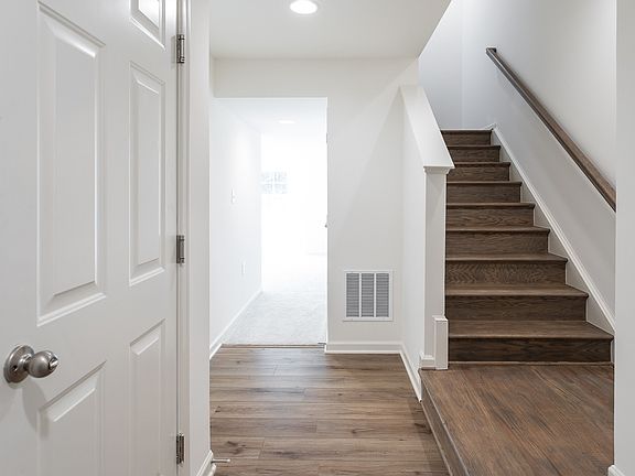 Front entry with wood floors and staircase in a DRB Homes York II Garage Plan in the Archer s Rock c
