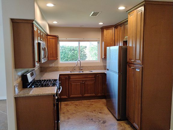 Lots of cabinets in this kitchen including a large panty.