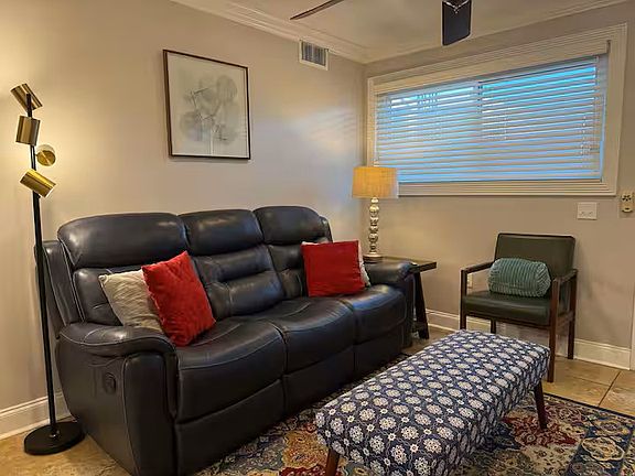 Spacious living room with genuine leather reclining couch