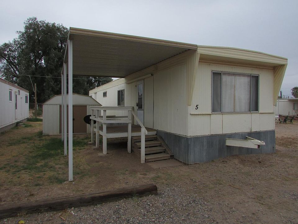 Front of house with patio cover and storage shed