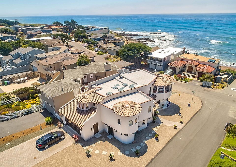 Overlooking crashing waves on flat terrain street perfect for exercising and bike rides. View is unobstructed through wide public access beach right in front of the edge of the property