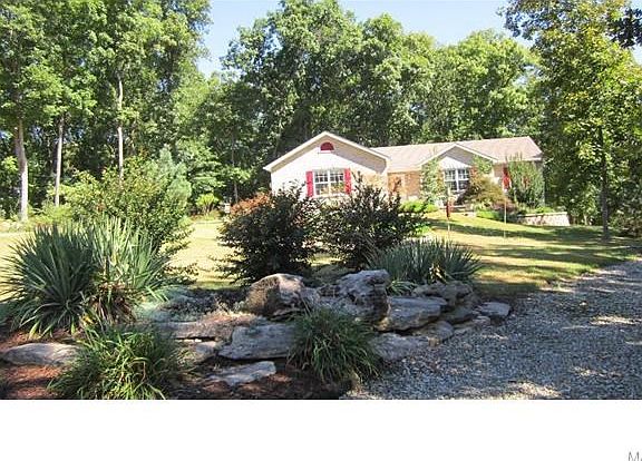 Front of home with concrete driveway to far left of photo.  There is a gravel drive to the far right of the home for convenience.