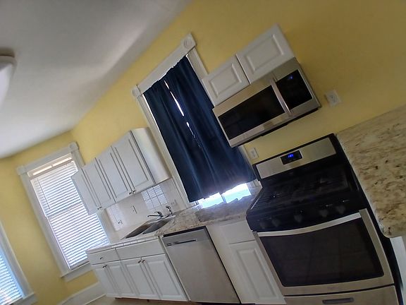 Kitchen area includes fridge, stove & 
dishwasher.